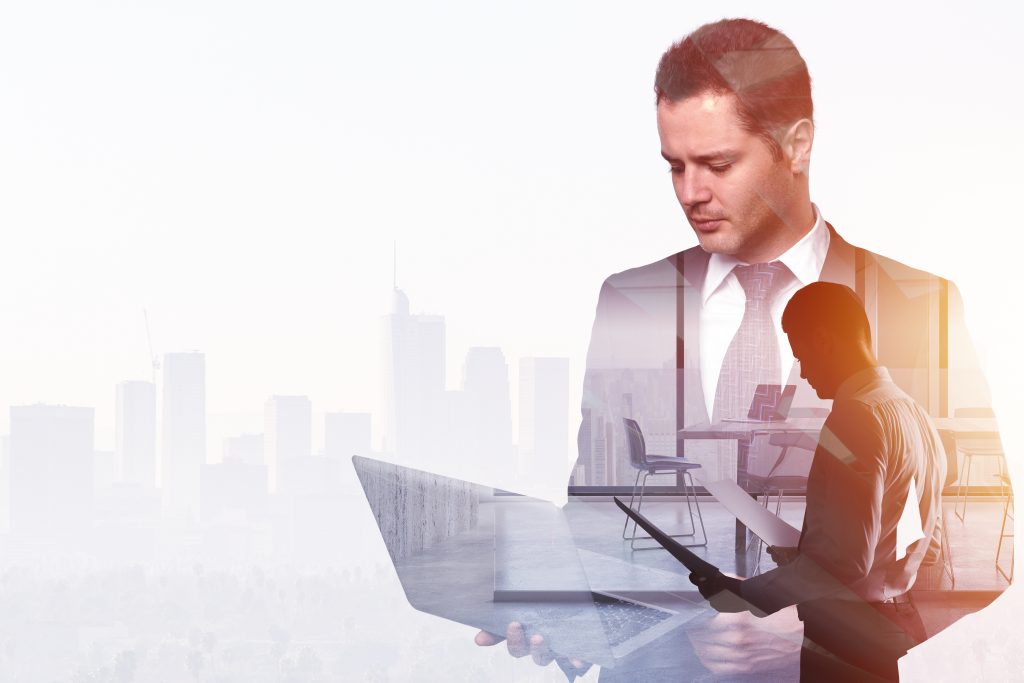 Businessman using laptop and holding contract on abstract office and city background with copy space. Finance and technology concept. Double exposure